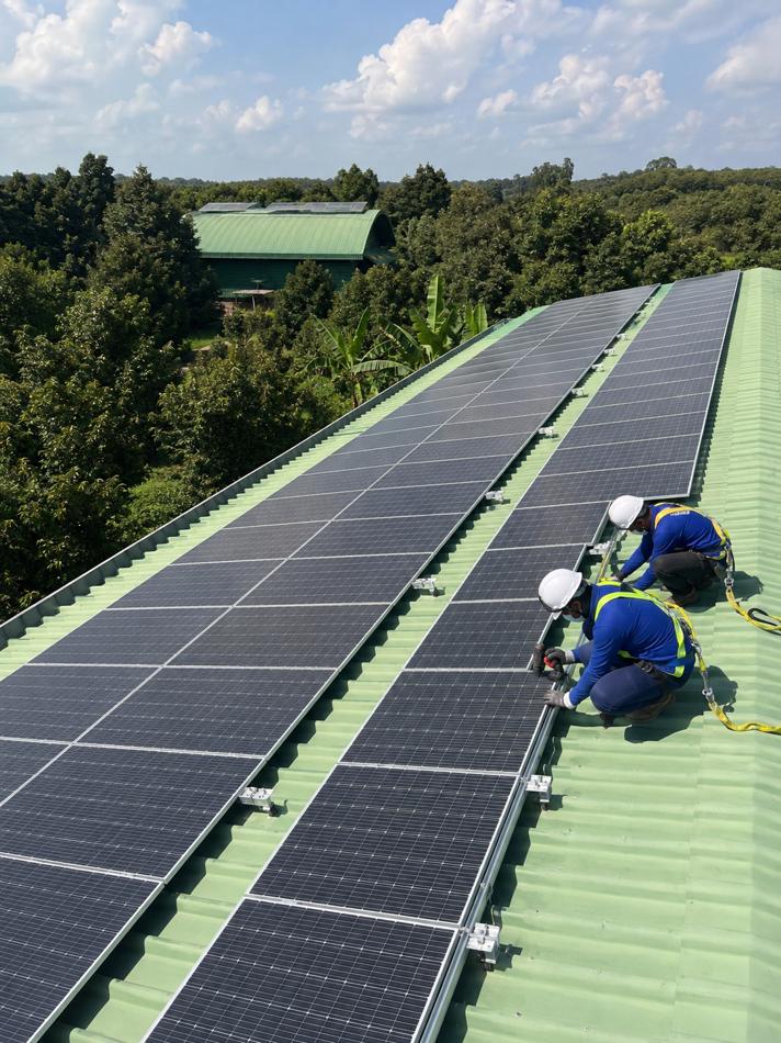 ผลงานติดตั้ง ท่าข้าวโรงสีพงษ์นิยม 100 kW — ทีมช่างยึดแผงบนหลังคาโรงสี